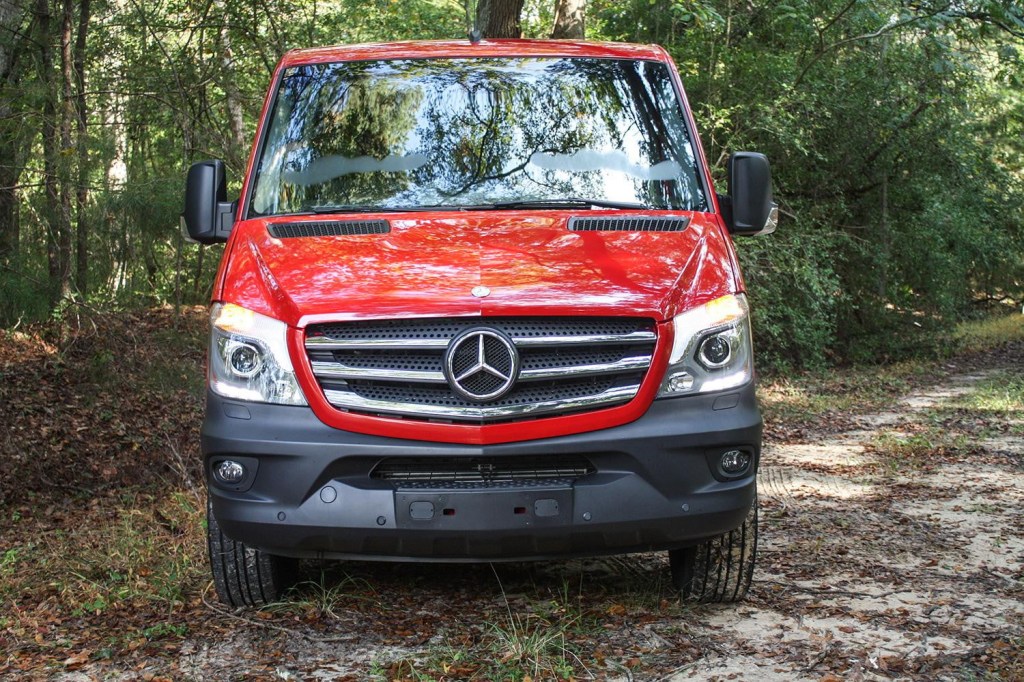 A red grille view of a 2015 model year used Mercedes Sprinter van