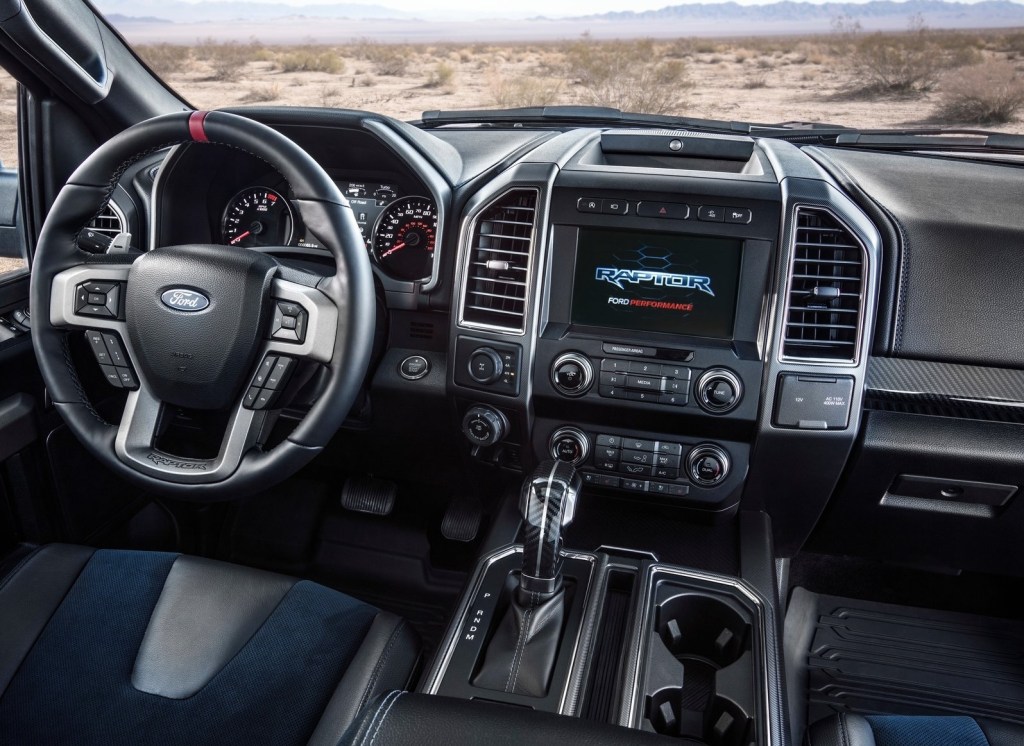 Interior shot of the 2019 Ford F-150 Raptor, showing blue-insert seats