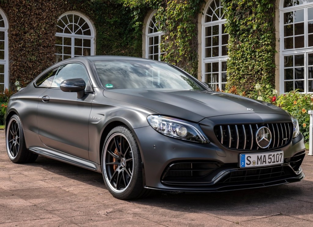 A matte-gray 2019 Mercedes-AMG C63S coupe in front of an ivy-covered building