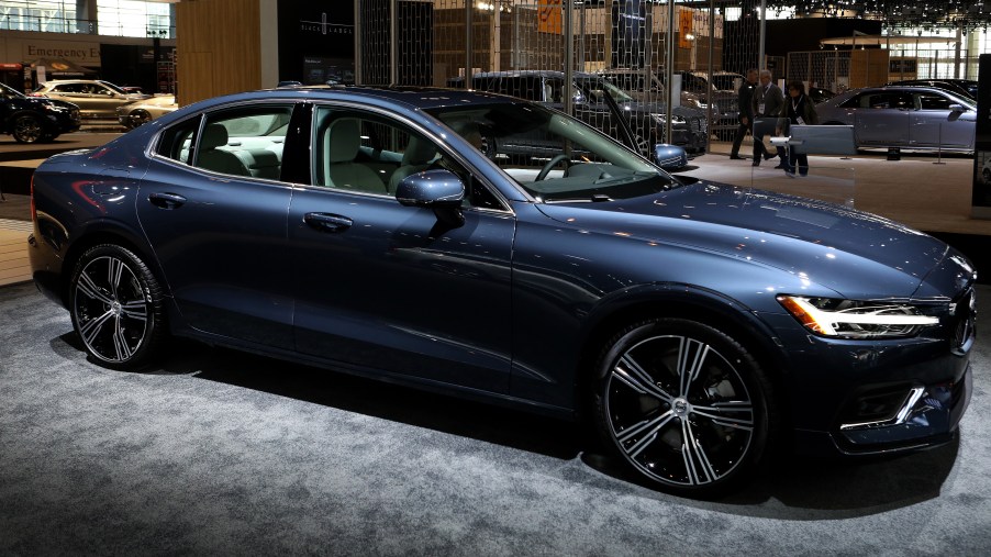 A blue 2019 Volvo S60 sits on display at a car show.