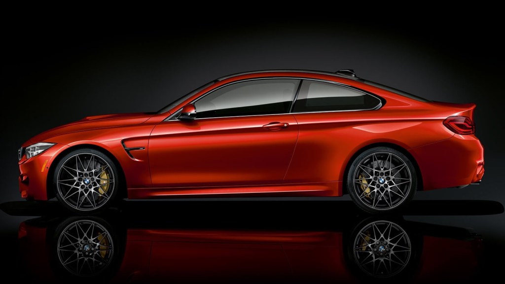 Side view of an orange 2020 BMW M4 coupe