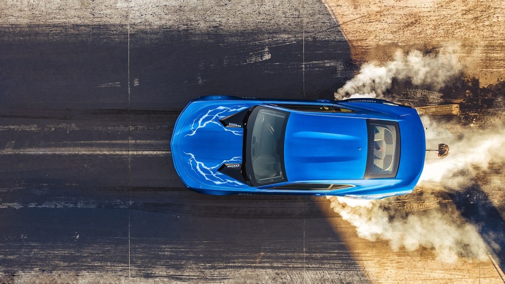 An overhead shot of a blue 2020 Chevrolet 50th Anniversary COPO Camaro does a burnout on the dragstrip