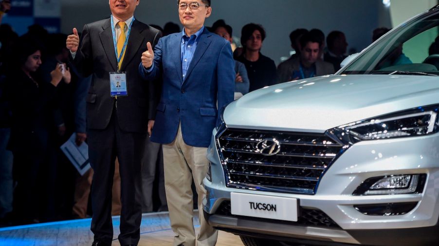 Managing Director (MD) and CEO of Hyundai Motors India Ltd, Seon Seob Kim (R), poses during the launch of Hyundai Tucson car at the Auto Expo 2020