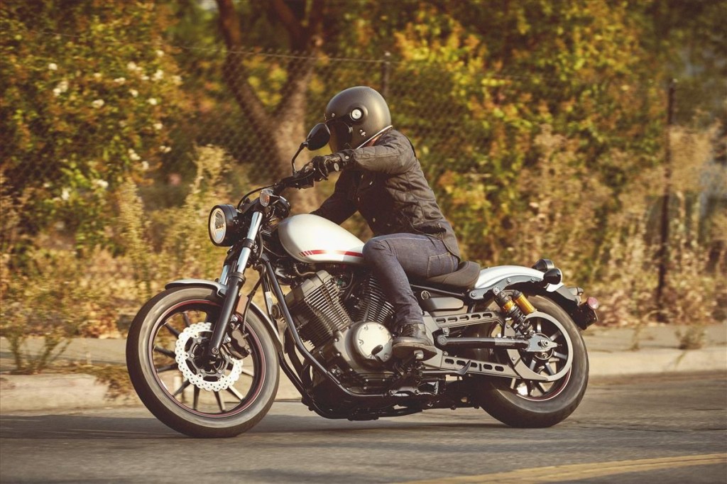 A black-clad rider on a white-and-red-tanked 2020 Yamaha Bolt R-Spec cruiser