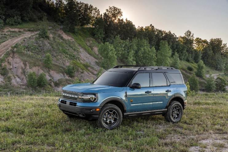 blue 4-door 2021 Ford Bronco Sport parked in grass on off-roading trail