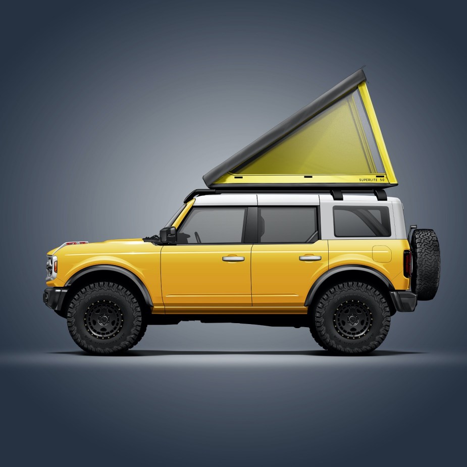 A yellow 4-door 2021 Ford Bronco with a Go Fast Campers SuperLite rooftop tent