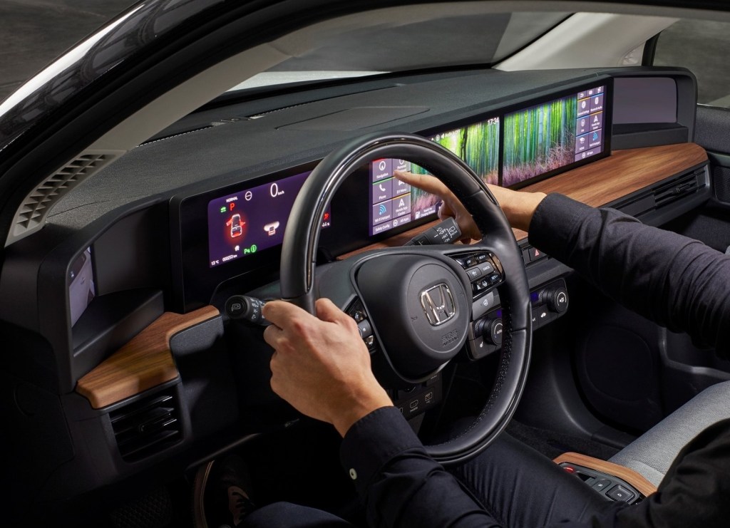 A close-up shot of the 2021 Honda E's dashboard, showing the configurable screens with a bamboo forest