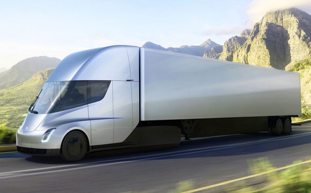 This is a rendering of a silver Tesla Semi electric tractor-trailer on a road along a mountain pass. 