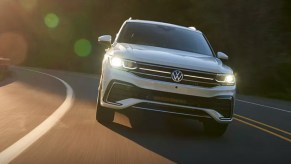 A white 2022 Volkswagen Tiguan is driving on the road.