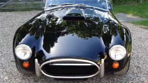 A head-on picture of a black Cobra convertible