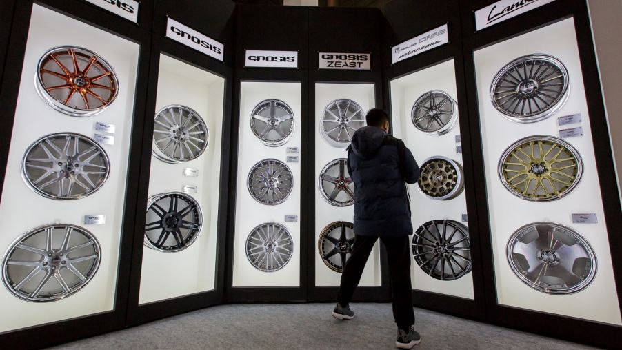 A selection of various aftermarket wheels in various sizes arranged in display cases