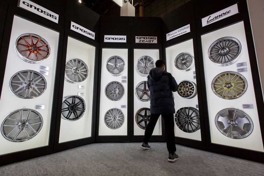 A selection of various aftermarket wheels in various sizes arranged in display cases
