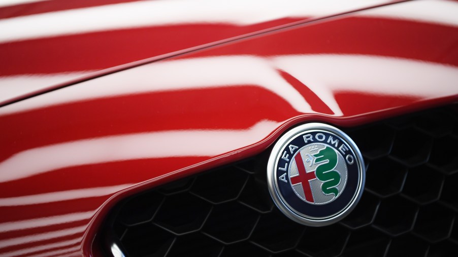 The Alfa Romeo logo on a red car.