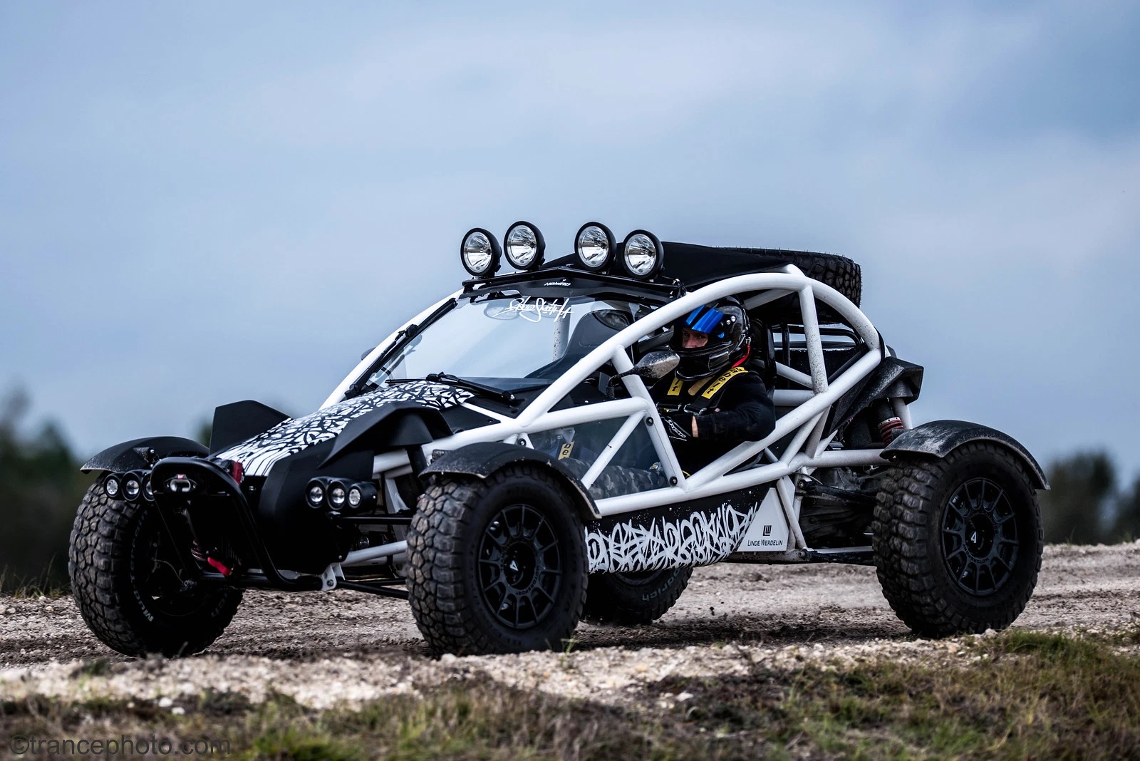 White-framed Ariel Nomad Tactical parked on a gravel road