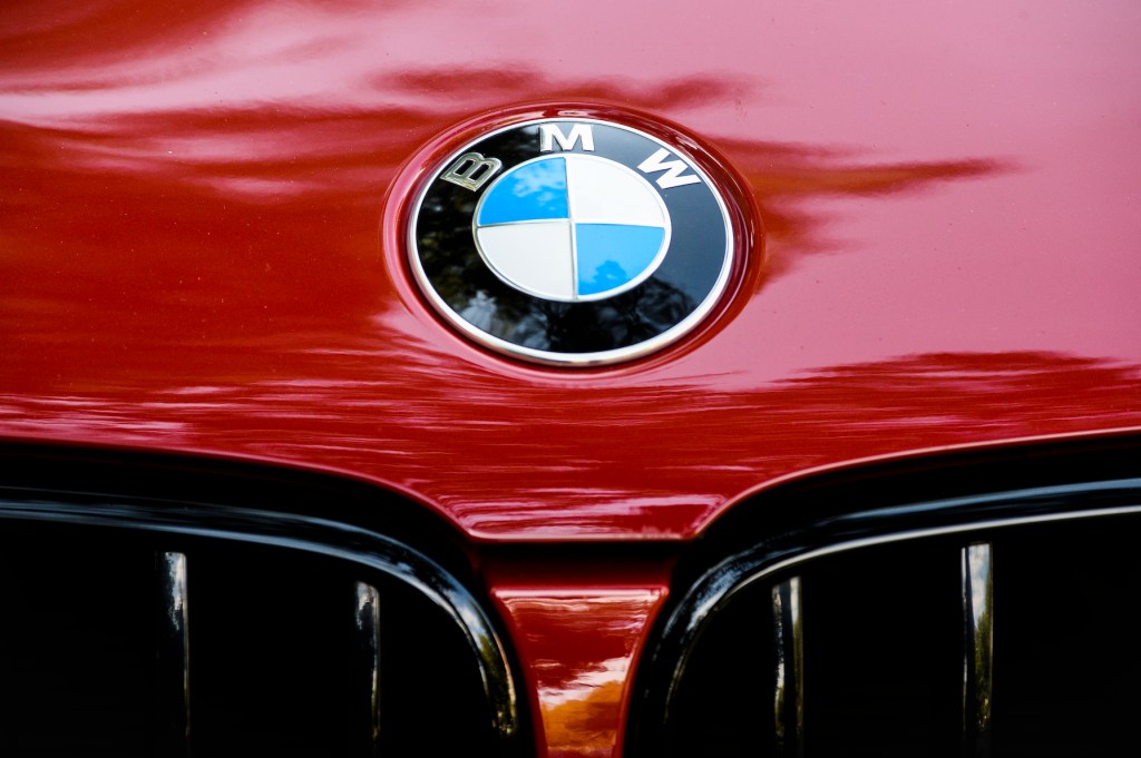 A BMW emblem is seen on a red car in Bucharest, Romania