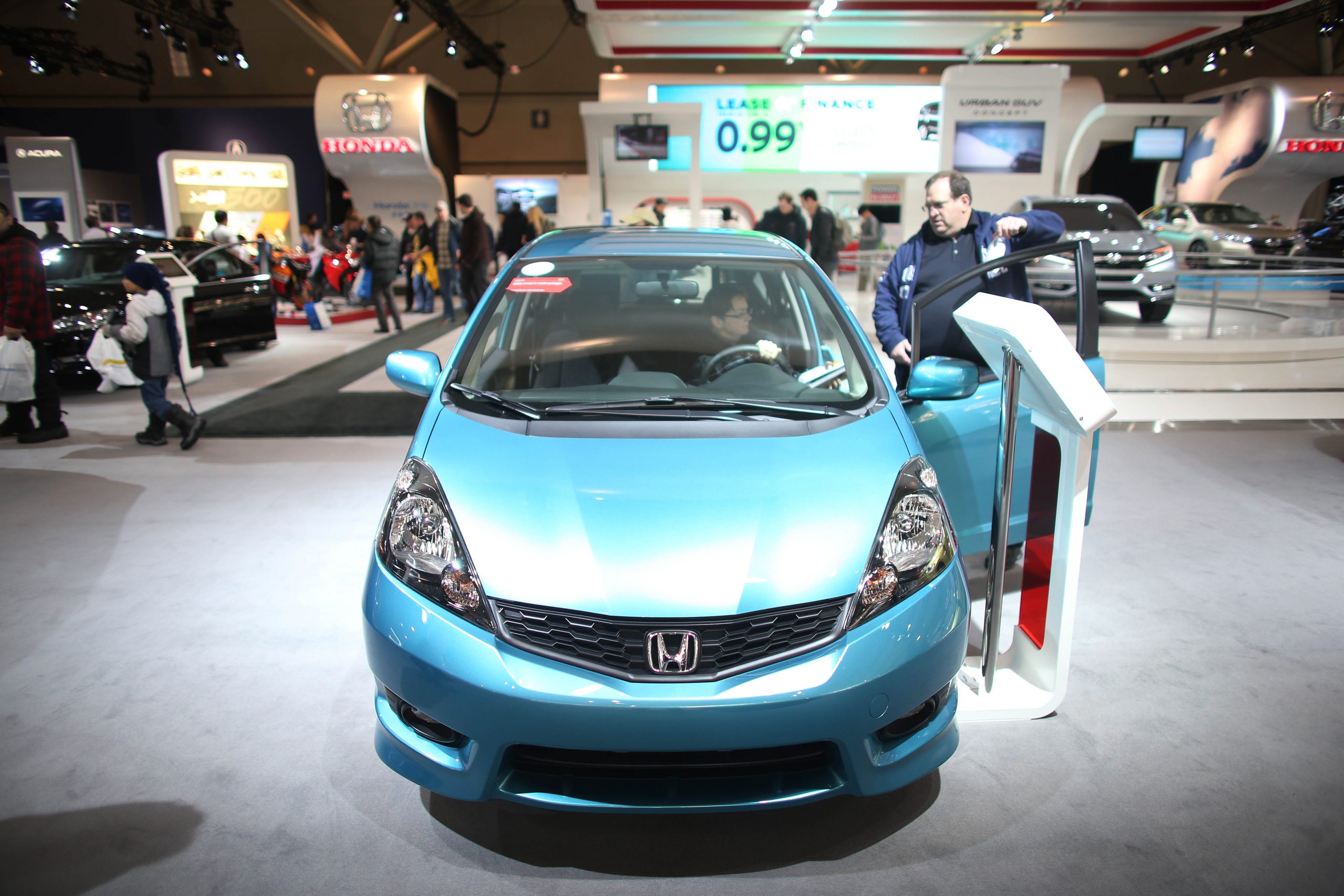 A blue Honda Fit on display at an auto show