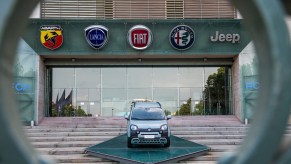The logos of automobile companies (L-R) Abarth, Lancia, Fiat, Alfa Romeo and Jeep are pictured at the entrance to the Fiat Chrysler Automobiles (FCA)