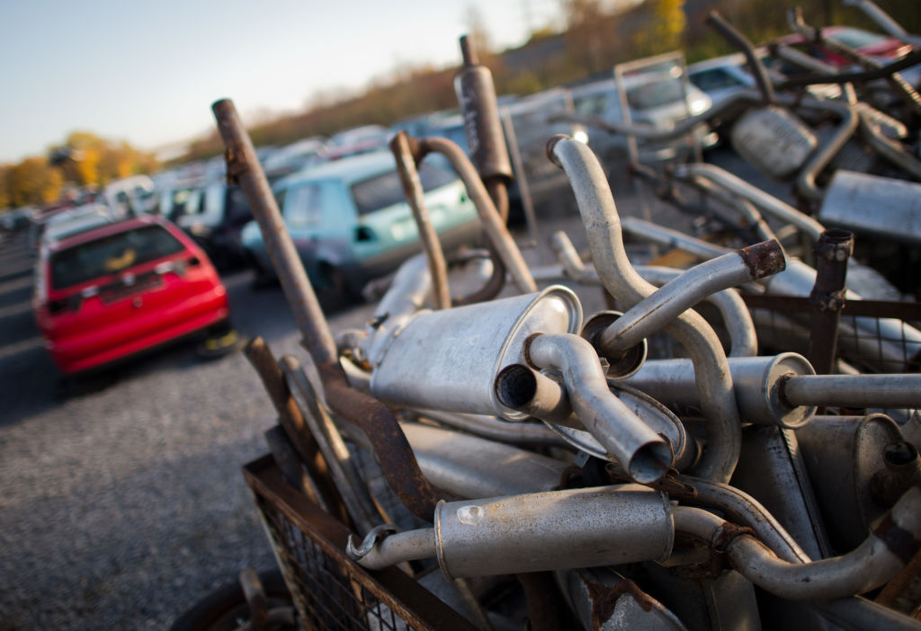 Old exhaust pipes lie in a junk yard | Julian Stratenschulte/picture alliance via Getty Images