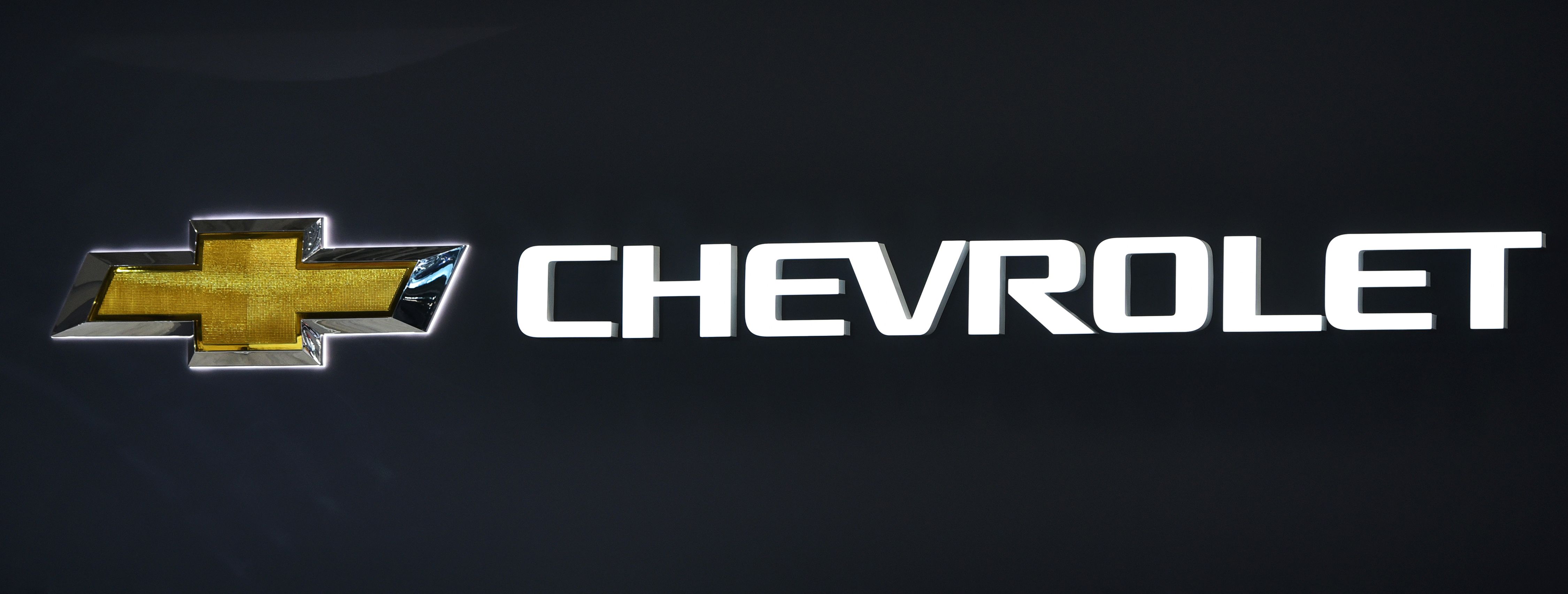 A gold Chevrolet bowtie logo and the Chevrolet script next to it.