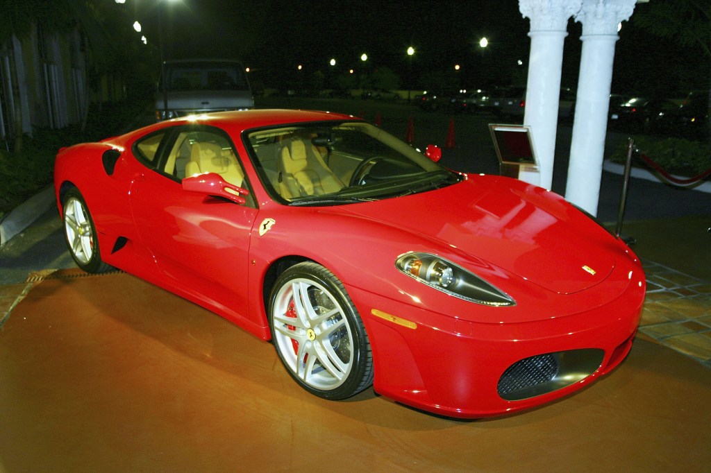 A red Ferrari F430 sports car sits on display at a show