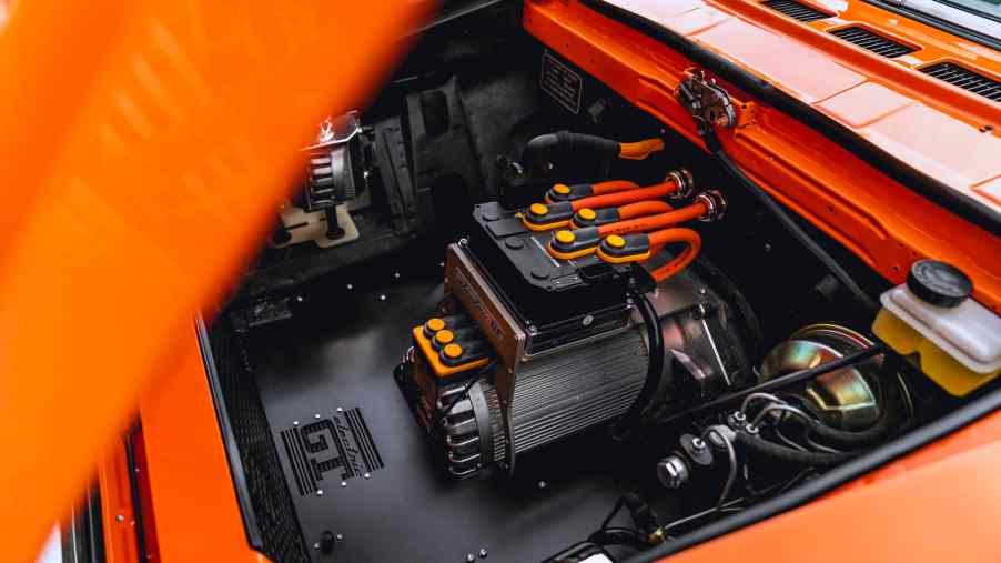 The hood is raised on a 1982 Fiat Spider to expose the electric crate motor swap.