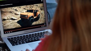 This illustration picture shows a person watching the 2021 Ford Bronco Family World Premiere on a computer in Arlington, Virginia