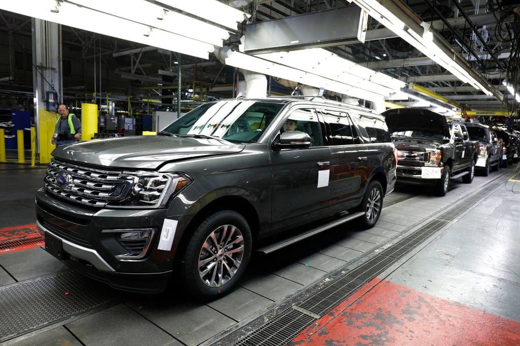 Factory workers assemble Ford Expeditions