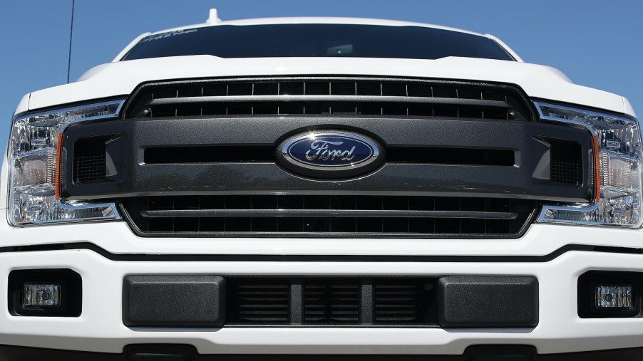 The front grill of a white Ford F-150 pickup truck is seen on Metro Ford's sales lot