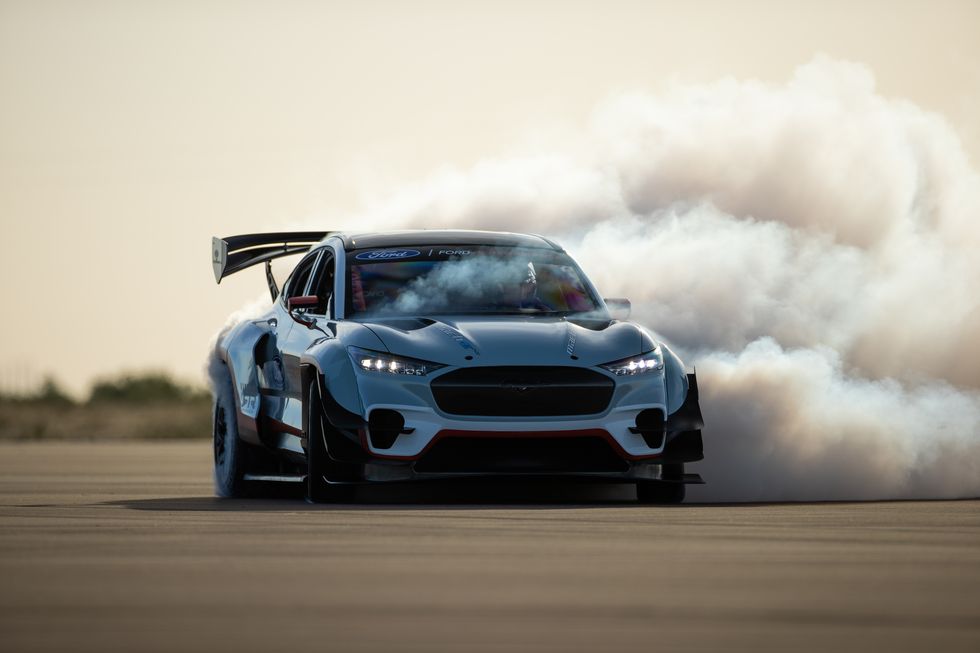 The prototype Ford Mustang Mach-E drag race car doing a sideways burnout