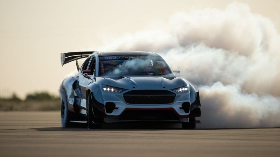 The prototype Ford Mustang Mach-E drag race car doing a sideways burnout