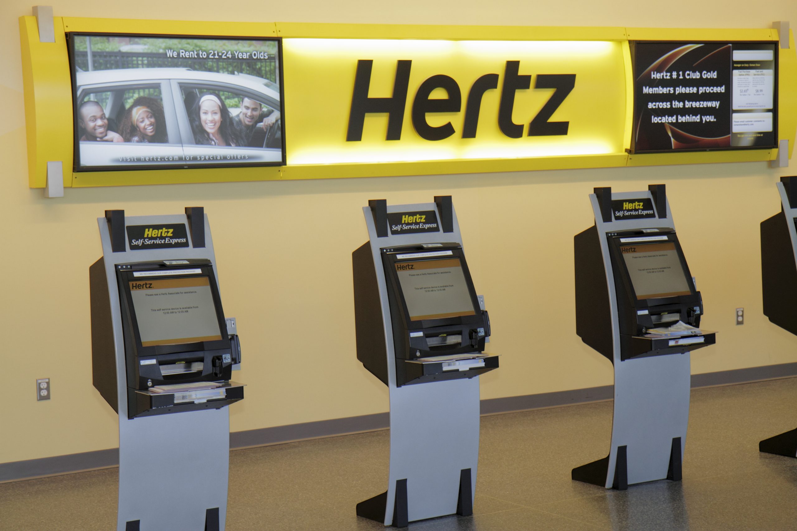 three Hertz rental kiosks have no one using them.