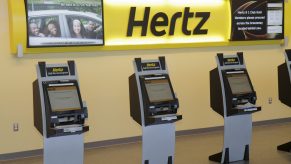 three Hertz rental kiosks have no one using them.