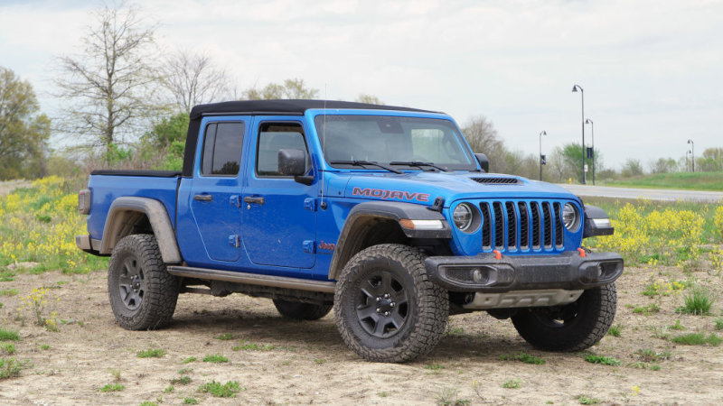 Hydro Blue Jeep Gladiator pickup truck parked in sand
