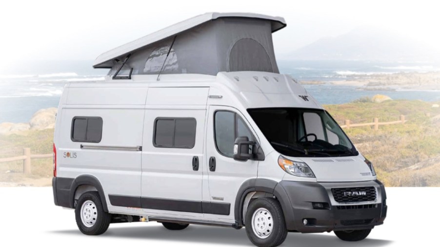 Winnebago Solis RV camper with it's roof tent popped open, parked with a Mountain View