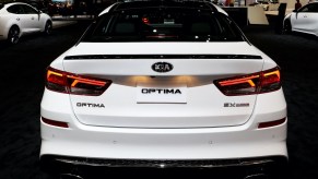 The rear of a white precursor of the 2020 Kia Optima on display at the Annual Chicago Auto Show