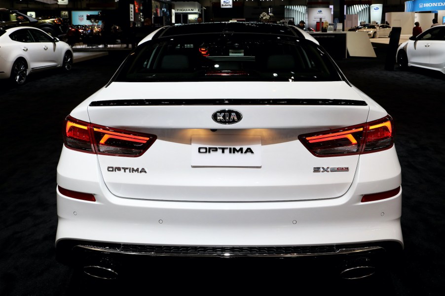 The rear of a white precursor of the 2020 Kia Optima on display at the Annual Chicago Auto Show