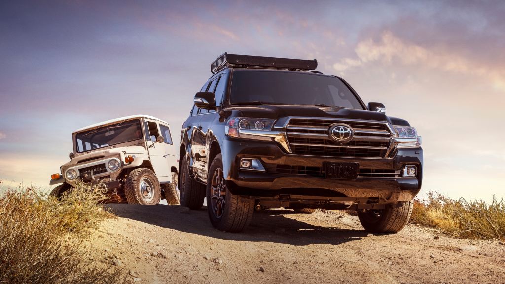 2020 Toyota Land Cruiser off-roading through sand. Large Luxury SUVs