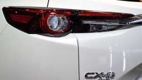 A white Mazda CX-9's rear badge