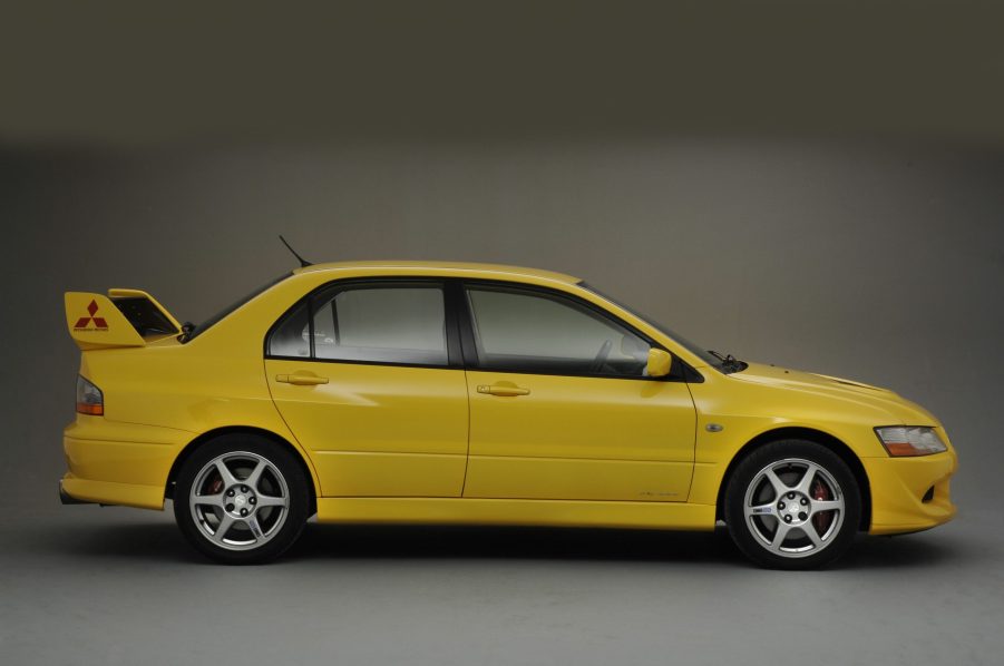 A yellow Mitsubishi Lancer with a spoiler