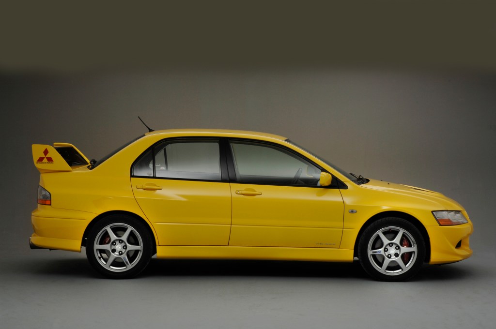 A yellow Mitsubishi Lancer with a spoiler