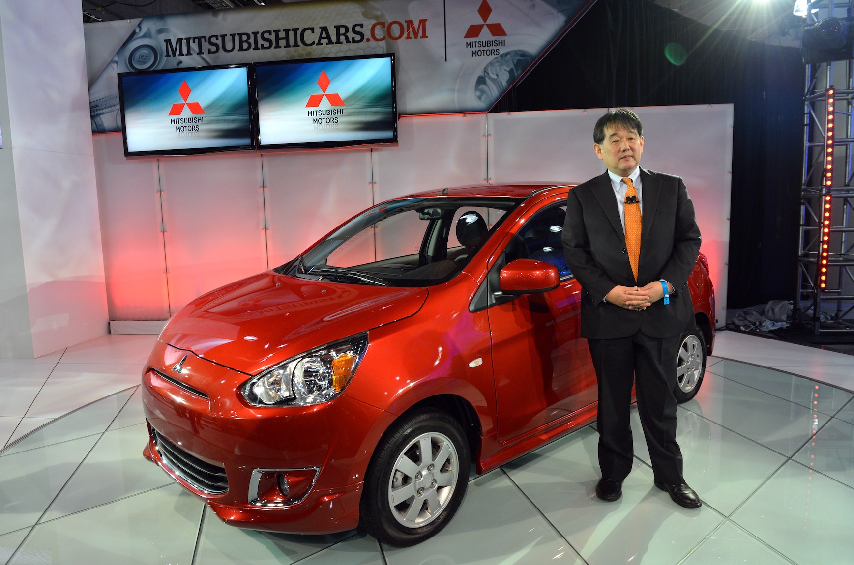Yoichi Yokozawa in front of the 2014 Mistubishi Mirage, unveiled during the second press preview day at the New York International Automobile Show