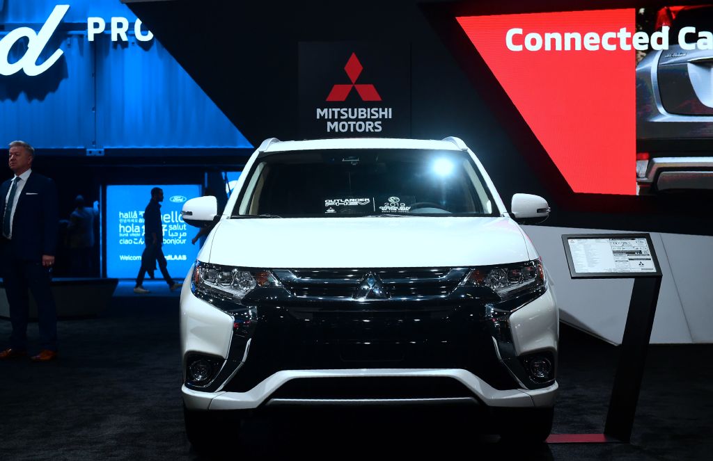 A white Mitsubishi Outlander on display at an auto show