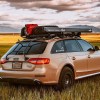 Rear view of a tan modified 2015 Audi A4 Allroad in an open sunset field