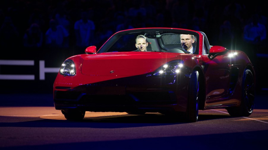 Karolina Pliskova from the Czech Republic (L) driving a Porsche 718 Boxster GTS with the CEO¬†of Porsche AG, Oliver Blume, in the Centre Court during the award ceremony after her victory against Vandeweghe from the US