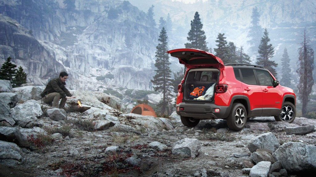 2020 Jeep Renegade with man camping nearby 