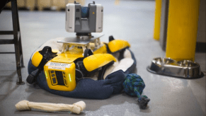 A robot dog recharging in it's bed at the Ford plant