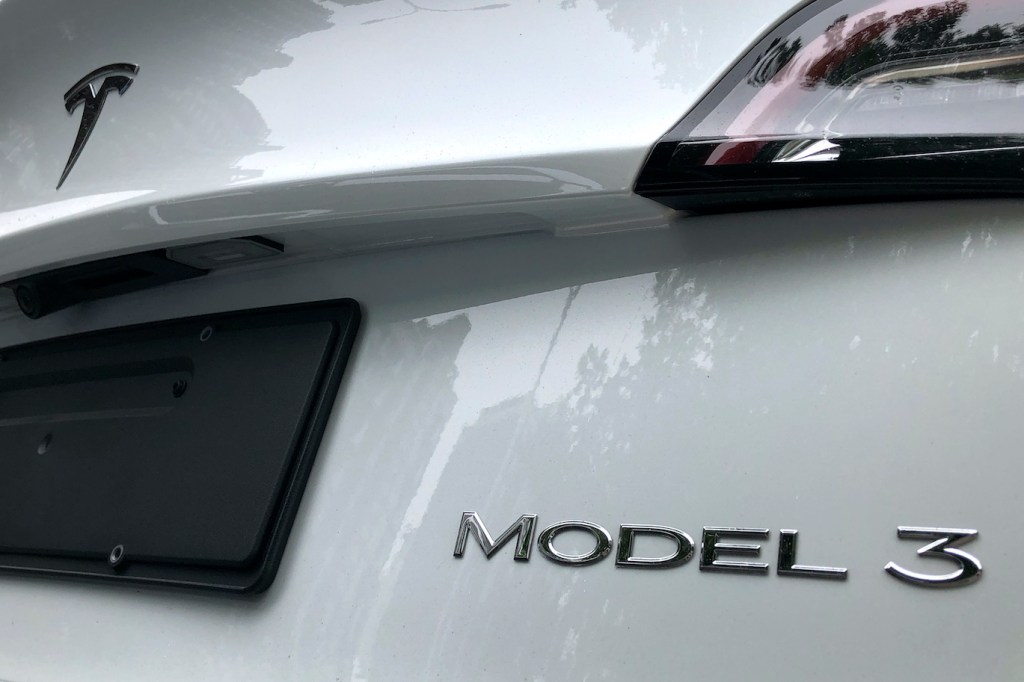 The rear badge of a white Tesla Model 3 is seen on July 17, 2020 in Beijing, China