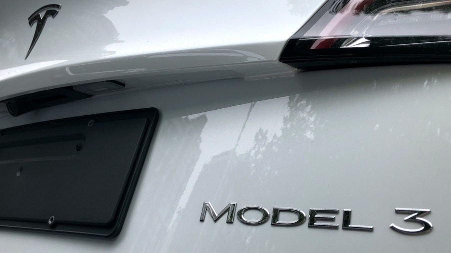 The rear badge of a white Tesla Model 3 is seen on July 17, 2020 in Beijing, China