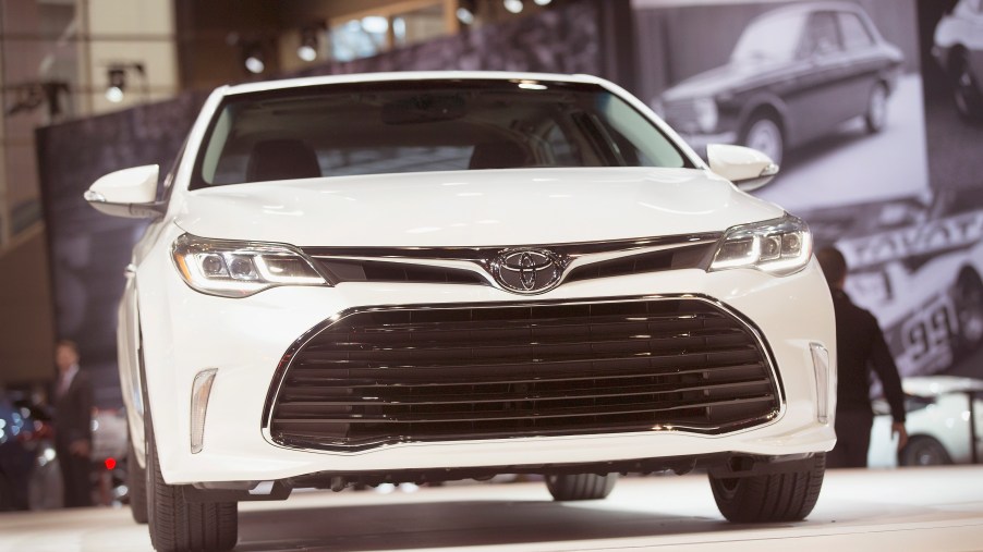A white Toyota Avalon on display at an auto show