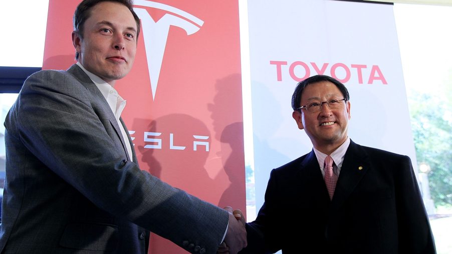 The CEOs of Tesla and Toyota shaking hands